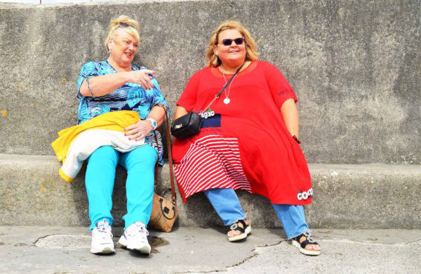 © ECPO Media Center https://ecpomedia.org/image/a-couple-of-women-sitting-on-top-of-a-cement-bench/